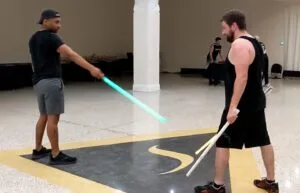 CM-Q telegraph — Saberist A points the saber tip down at 45°, Saberist B draws both sabers